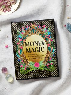 a book on money magic surrounded by crystals