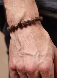 Chocolate Sunstone and Sterling Silver Men's Bead Bracelet - Brown Genuine Sunstone Geometric Gemstone Bracelet for Guys Cord: Brown Faux Leather Beads: 925 Sterling Silver Gemstones: Genuine Chocolate Sunstones Gemstone width: 8mm Adjustable. One Size Fits Most. Designed to fit average sized Men's Wrists from 6in to 8in Brown Gemstone Bracelet Gift, Brown Gemstone Bracelets, Bracelet For Guys, Sunstone Bracelet Gemstones, Brown Natural Stone Bracelet For Meditation, Hand-strung Brown Beaded Bracelets For Meditation, Leather Beads, Stainless Bracelet, Mens Beaded Bracelets