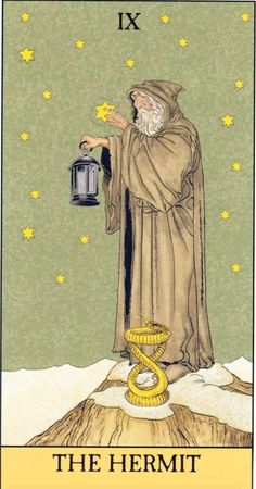 the hermit tarot card with an image of a man holding a lantern