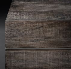 an old wooden box with metal handles on it's sides, against a black background