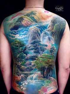 the back of a man's body with an image of waterfalls and trees on it