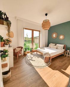 a bedroom with wooden floors and green walls, has a bed in the center surrounded by wicker baskets