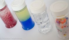 three bottles filled with different colored liquids sitting next to each other on a table