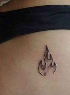 a woman's stomach with a small tattoo on it