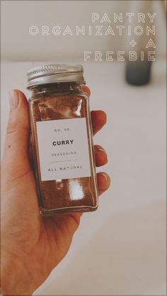 a person holding a jar of curry in their hand