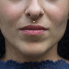 a woman with a nose piercing in front of her face