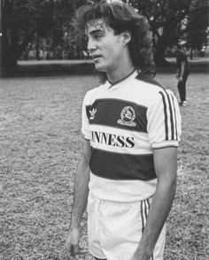 a young man standing on top of a soccer field