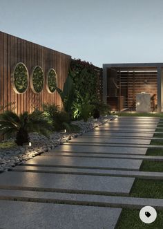 an outdoor area with steps and plants on the side of it at night, lit up by lights