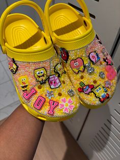 Hello, welcome to my shop   All custom designed shoes are made to order. Please allow 7-10 days to complete your order and 3-5 days for shipping.   When placing your order try to be as detailed as possible if you are not sure I can give suggestions or freestyle with charms, rhinestone, pearls and/or patches to match your chosen theme. No two crocs will be identical or match the listing picture exactly.   All sales are final on custom work. Some croc colors may not be available to me in the size Yellow Bedazzled Crocs, Junk Crocs, Croc Colors, Spongebob Crocs, Croc Inspiration, Decorated Crocs, Crocs Decorations, Croc Business, Customized Crocs Shoes