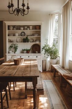 a wooden table sitting in the middle of a kitchen