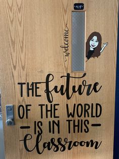 the future of the world is in this classroom door decal on a wooden door