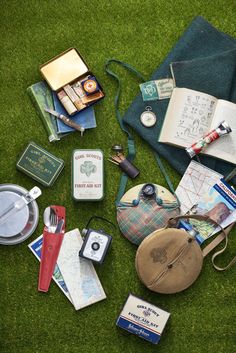 an assortment of items are laid out on the grass, including books and other things