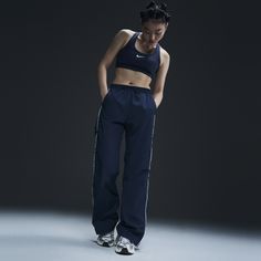 Reaching back to our roots, these easy-fitting pants pull inspiration from the Nike looks of the '70s. A water-repellent finish and UV technology built into the crinkle-woven fabric help keep you good to go come rain or shine. Nike Athletes, Nike Pants For Women, Nike Windrunner, Nike Looks, How To Hem Pants, Rain Or Shine, Women Lifestyle, Blue Nike, Nike Pants