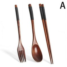 three wooden utensils with black handles are shown in this image, and one is made out of wood