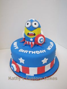 a blue birthday cake with an angry minion on top