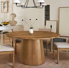 a dining room table with four chairs and a vase on the top of it in front of a busturine