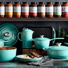 many pots and pans are sitting on the counter with food in front of them