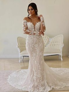 a woman in a wedding dress standing on a rug