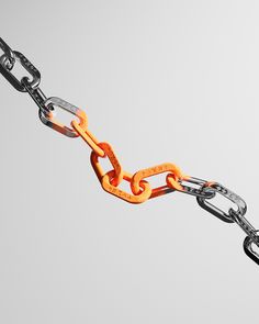 an orange and black chain is attached to a white background