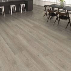 an image of a kitchen setting with grey wood flooring and bar stools in the background