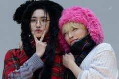 two young people wearing furry hats and scarves