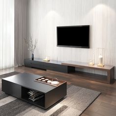 a living room with a large flat screen tv mounted on the wall above a coffee table