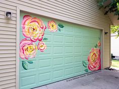 a painted garage door with flowers on it