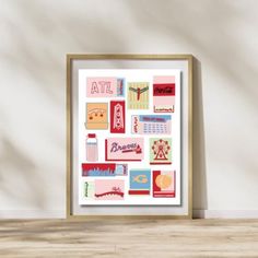 a framed art print with different types of items on the wall in front of it