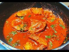 a pan filled with meat and sauce on top of a stove