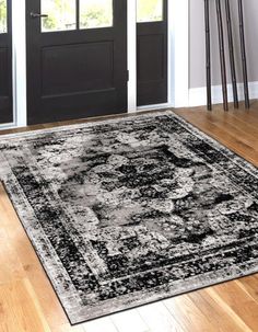 a black and white area rug in front of a door