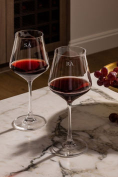 two wine glasses sitting on top of a marble counter