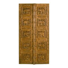 an intricately carved wooden door with elephants on it