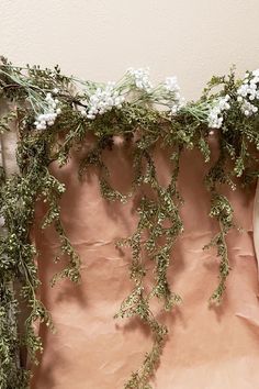 an arrangement of flowers and greenery on a table