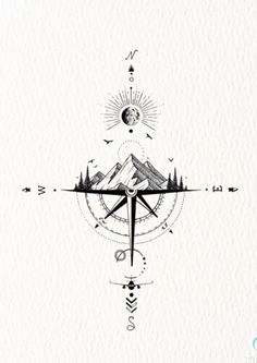 a compass with mountains and trees in the background, on top of a white paper