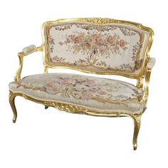 an ornately decorated couch with gold trimmings and floral fabric on the back