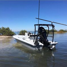 a small boat is in the water with its front end lifted up to it's side