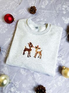 Reindeer Christmas Embroidered Sweatshirt *Christmas embroidered sweatshirt, embroidered crewneck, embroidered sweater, Christmas crewneck, embroidered Christmas, Christmas gift, holly and jolly, merry and bright, the season for giving, spooky season* ABOUT THIS SWEATSHIRT: This crewneck is the perfect solution for what to wear the next time you're feeling the holiday spirit. It's cozy soft and has a unisex fit that can be styled any number of ways. Embroidered with special care, it's sure to last you a lifetime (unless you eat too many candy canes while wearing it). Every sweatshirt is hand made to order and usually takes between 5-7 business days to ship, so please plan in advance if you're looking for something to wear to a holiday party or to give as a gift! This is a unisex crewneck s Christmas Crewneck Sweatshirt Embroidery, Christmas Crew Neck Sweatshirt With Embroidered Logo, Christmas Crew Neck Sweatshirt With Embroidered Graphics, Christmas Embroidered Crew Neck Sweatshirt, Holiday Embroidered Crew Neck Sweatshirt, Embroidered Crew Neck Sweatshirt For Holiday, Christmas Embroidery Sweatshirts, Embroidered Christmas Sweatshirt, Christmas Sweaters Women