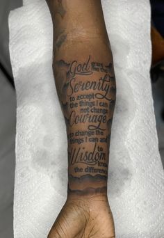 a person's arm with a tattoo on it that says god is the serenity