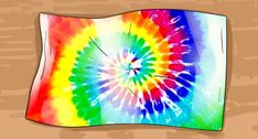 a colorful tie - dyed piece of paper on a wooden surface with the colors of rainbow