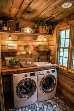 a washer and dryer in a small room with wood paneling on the walls