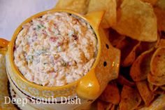 a bowl of dip surrounded by chips