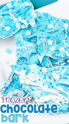 frozen chocolate bark on a white plate with blue sprinkles in the background