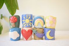 a group of colorful clay blocks sitting on top of a white table next to a potted plant