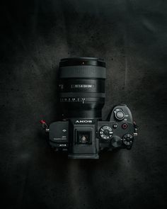 a camera with a lens attached to it's body on a black background,