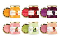 six jars of different types of jams in various colors and flavors, all with labels on them