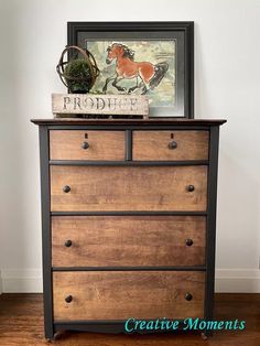 a dresser with drawers and a painting on top