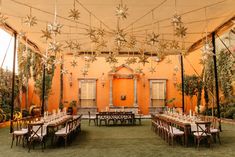 an outdoor venue with tables and chairs set up for a formal function in the garden