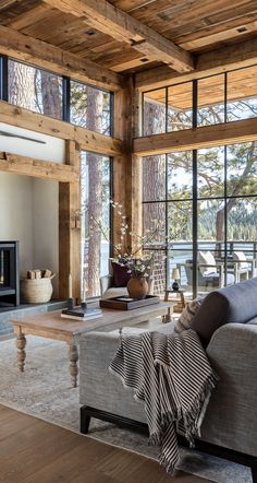 a living room filled with furniture and a fire place in front of a large window