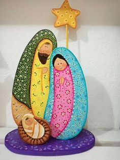 a nativity figurine with three people and a star