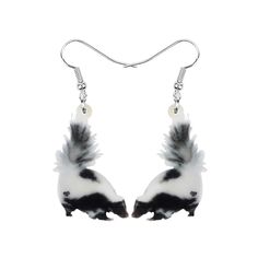 a pair of earrings with black and white feathers